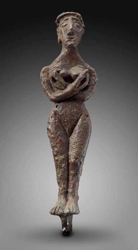 Female figurine holding breasts