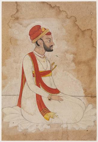Seated man with a red turban and scarf