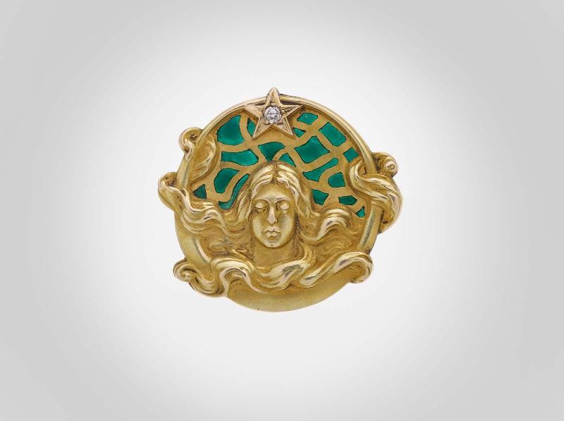 Brooch featuring a female head with curvilinear tresses