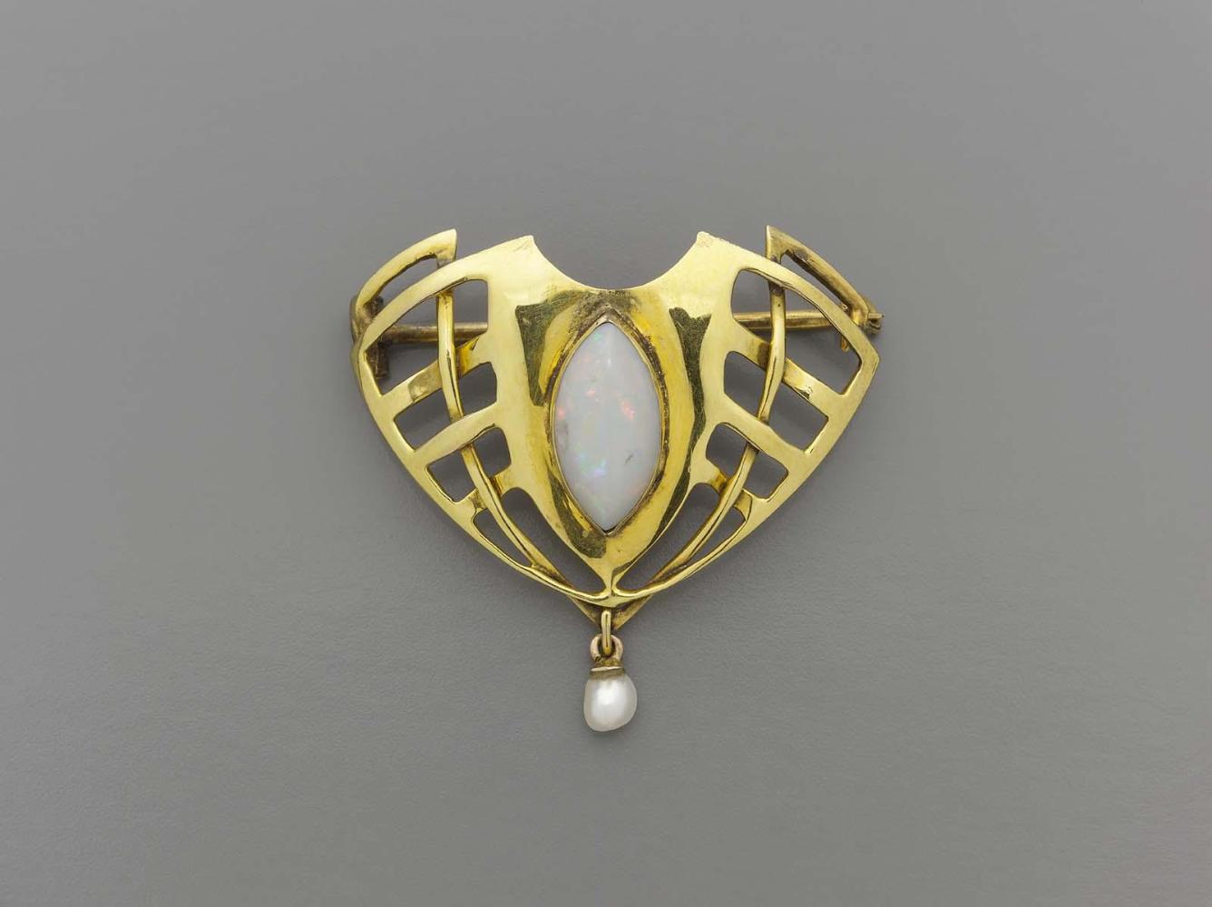 Sessionist-style brooch with a central, marquis-shaped opal