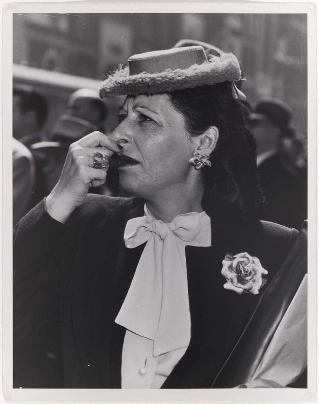 Untitled (Well-Dressed Woman in a Crowd Looking at Something with Concern)