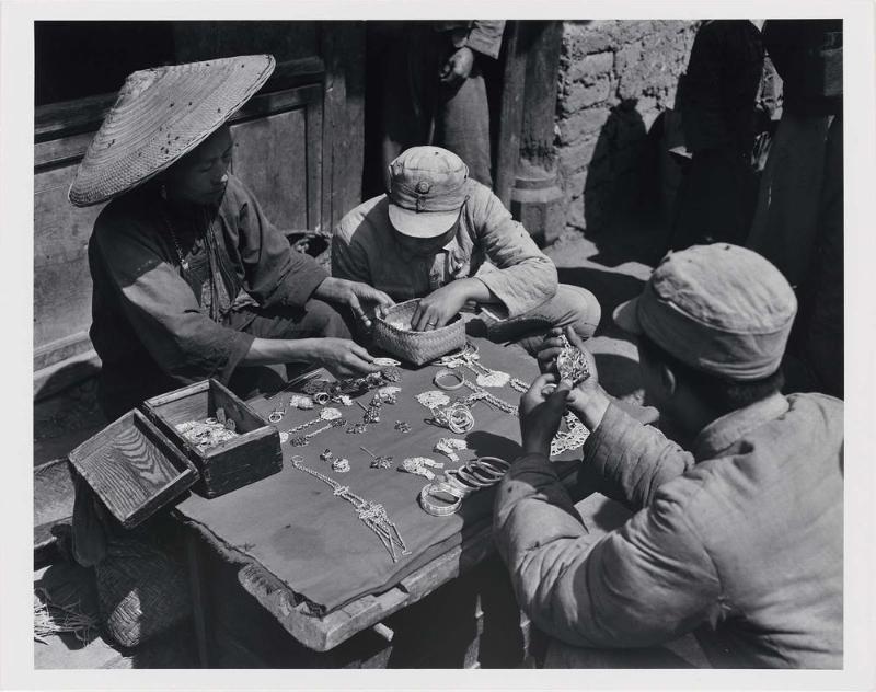 Soldiers Selecting Silver Jewelry at a Small Town Market