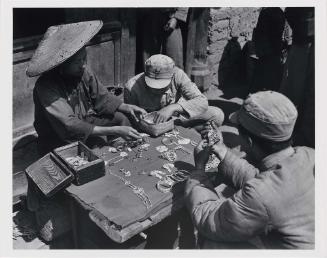 Soldiers Selecting Silver Jewelry at a Small Town Market