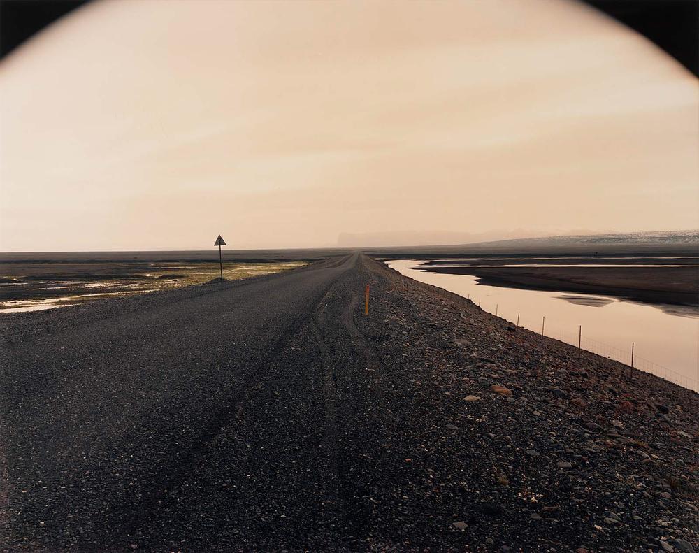 No Ordinary Land: Ring road as it passes between the Black Sand Desert and the glacier-covered volcano Katia, Myrdalssandur, Iceland