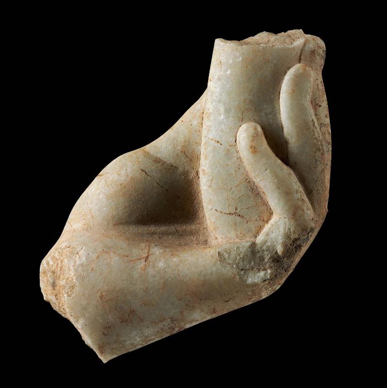 Left hand holding alabastron