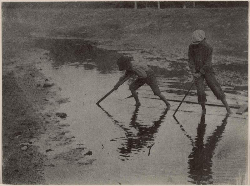 Two Boys Playing in a Stream