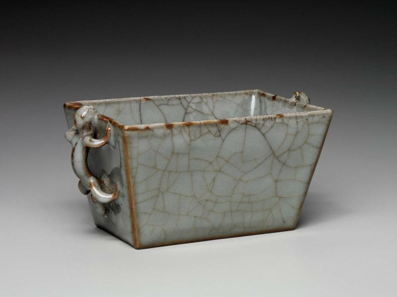 Rectangular vessel with molded and applied lizard-shaped handles decorated withj blue glaze with large crackles