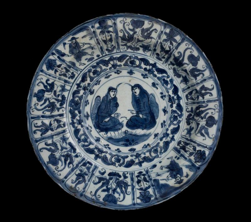 Large, deep plate with blue-and-white decoration of Middle Eastern figures and flowers