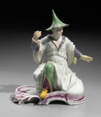 Figure of a seated man in Chinese costume