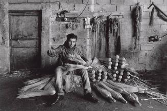 Untitled (young broom maker in his workshop)