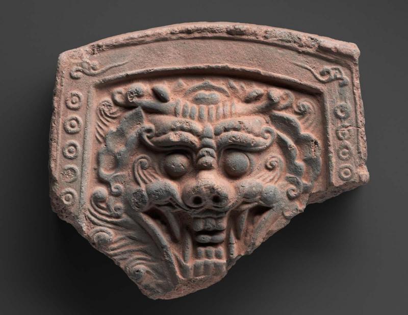 Roof tile with a demon face