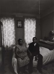 Untitled, [Elderly Couple Sitting on Bed with Christ on Wall], from East 100th Street series