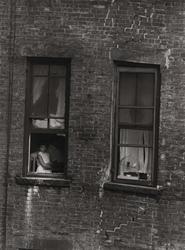 Untitled, [Child in Window with Birdcage in the Next Window], from East 100th Street series