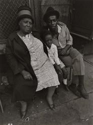 Untitled, [Mother, Son and Child Sitting in Front of Storefront], from East 100th Street series