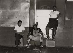 Untitled, [Two Men Sitting, One Woman Standing on Apple Box], from East 100 Street