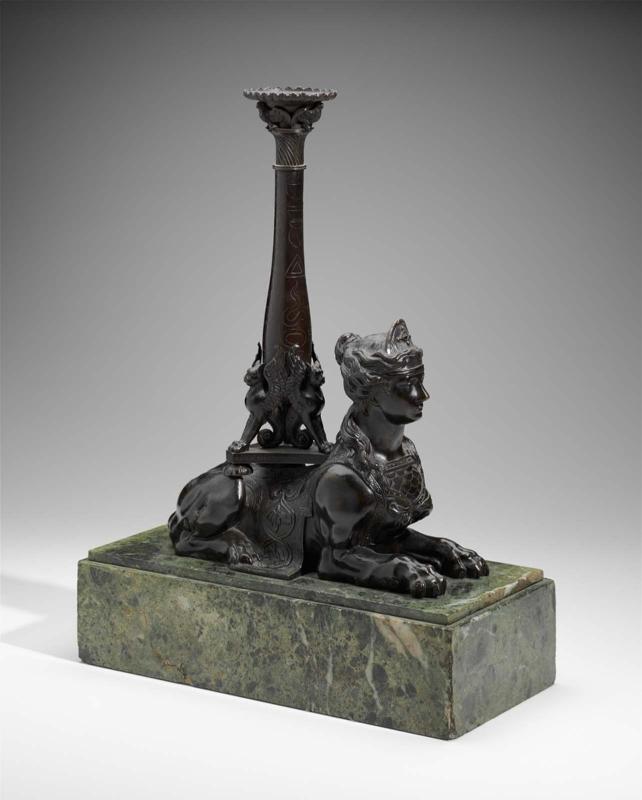 One of a pair of Egyptian 'sphinx' candlesticks