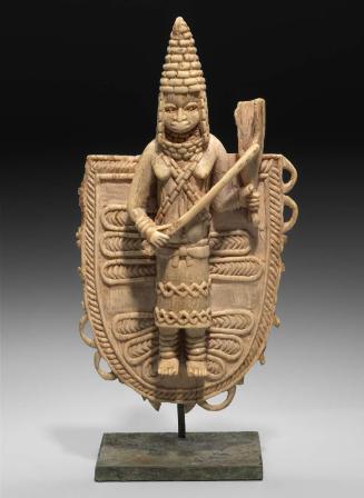 Pendant with a Queen Mother (Iyoba) playing a gong