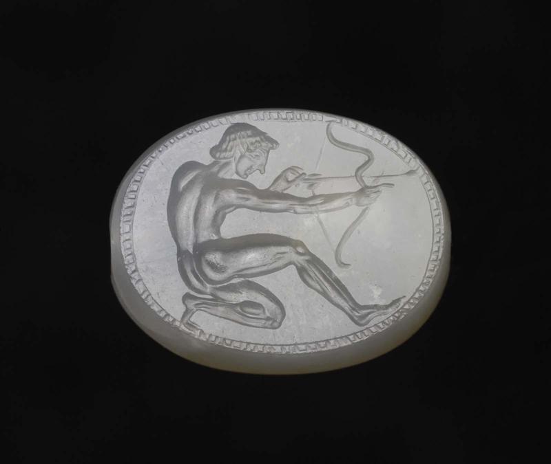 Scaraboid gem with a kneeling youth drawing a bow