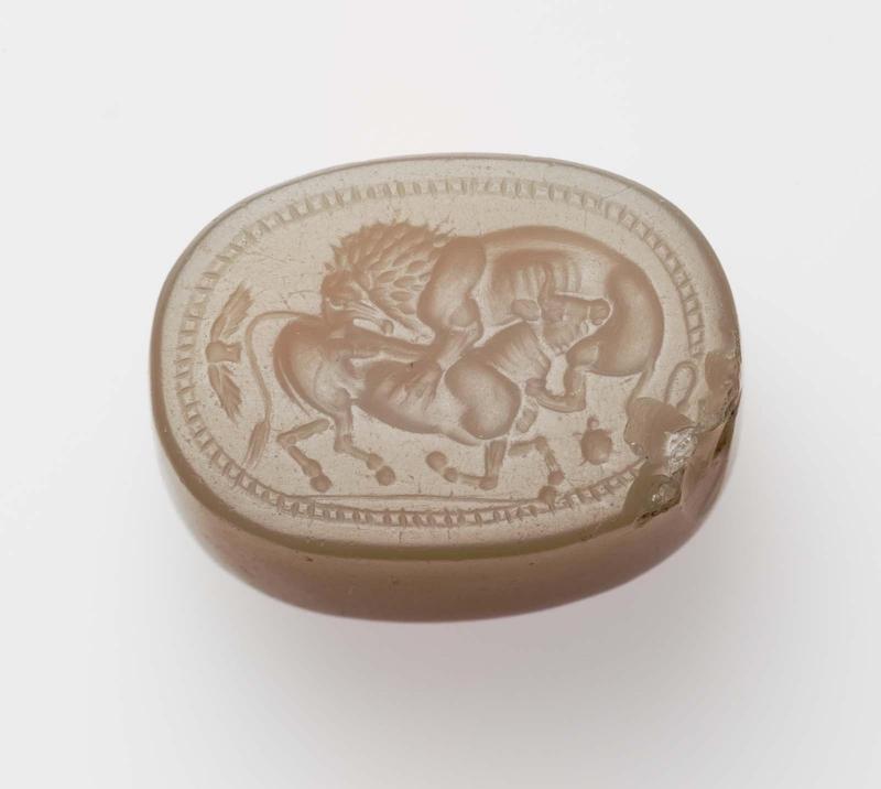 Scaraboid gem with a lion attacking a bull
