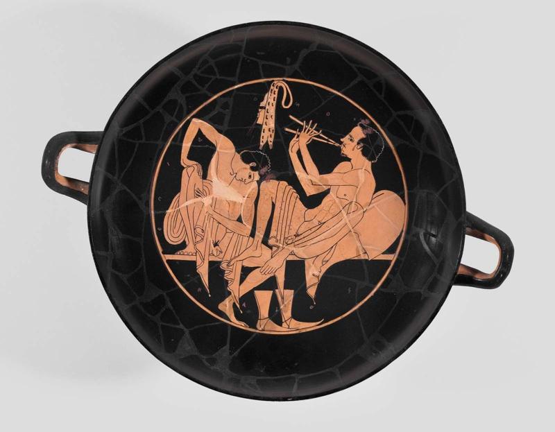 Drinking cup (kylix) depicting a symposium