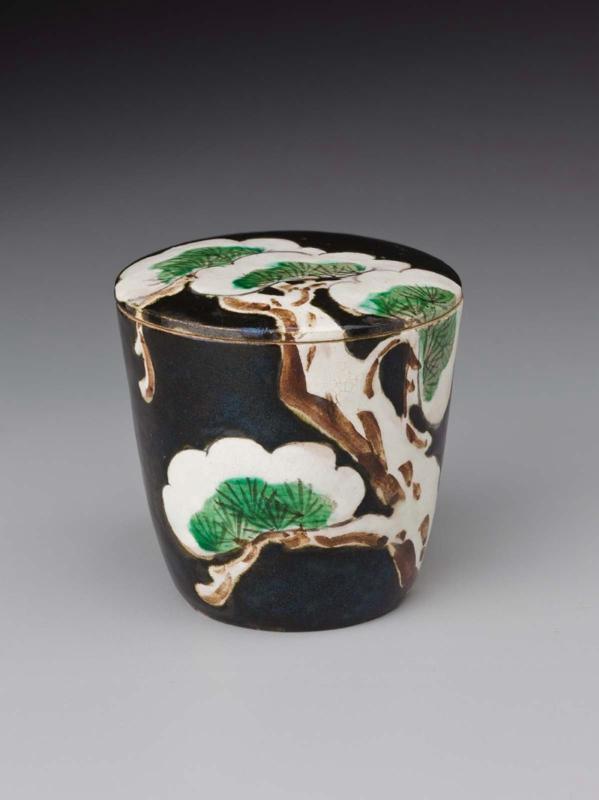 Tea container with snow-laden pine design
