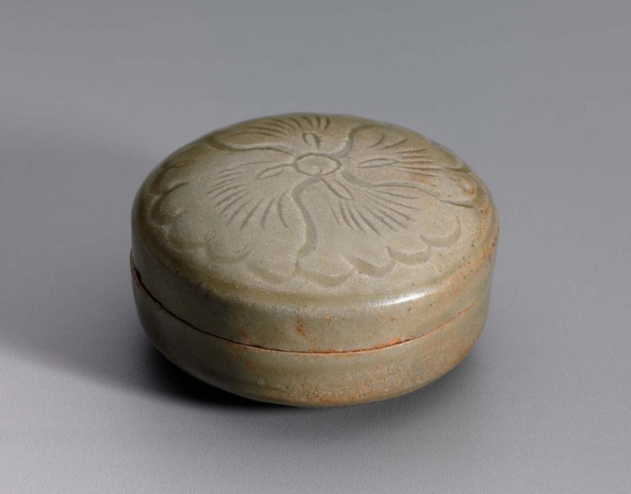 Small box with carved design under celadon glaze