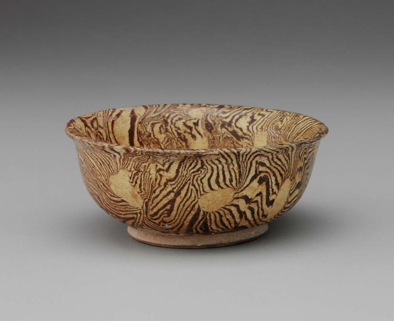 Marbelized shallow bowl decorated with amber glaze