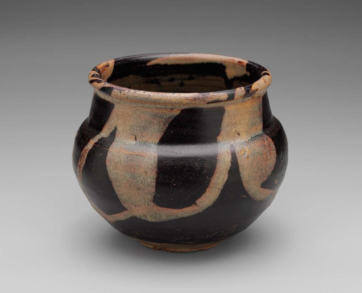 Bowl with trailed honey-colored glaze over dark-brown ground