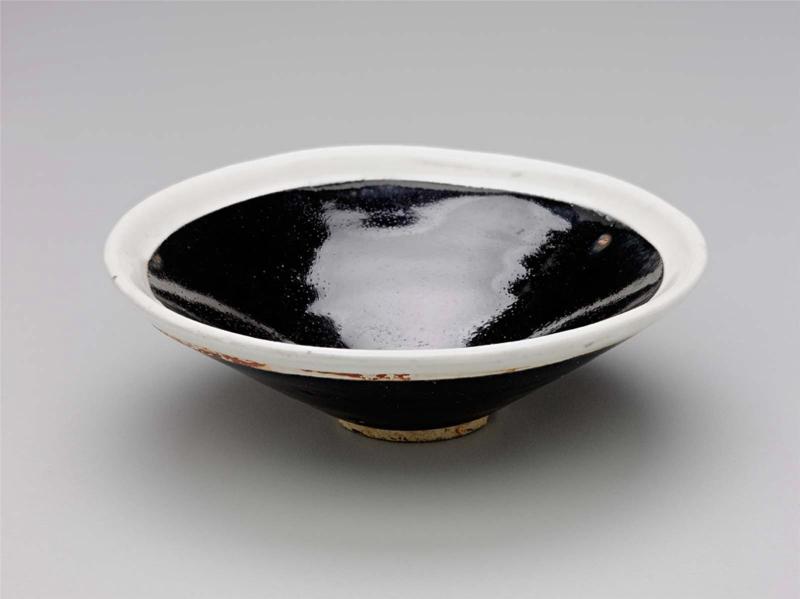 Conical bowl with black glaze and white rim