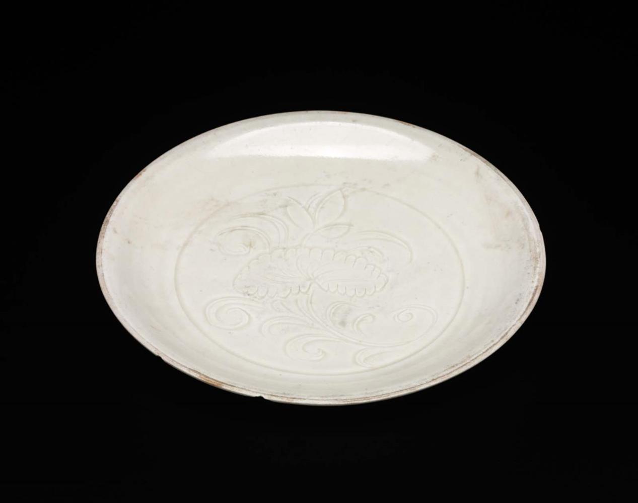 Small dish with carved floral design under ivory white glaze