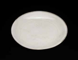 Small dish with carved floral design under ivory white glaze