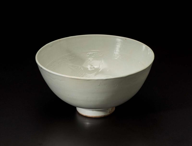 Bowl with molded designs of swans, clouds, and inscribed characters