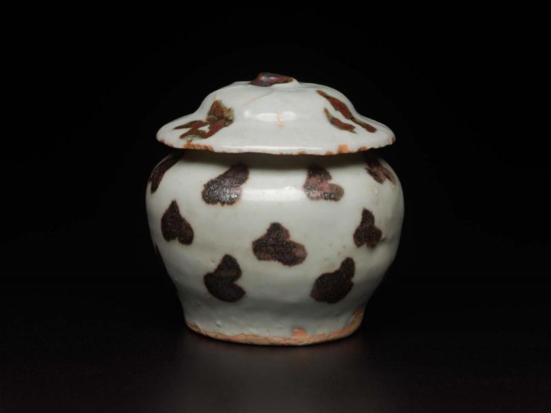 Miniature covered jar painted with iron dots