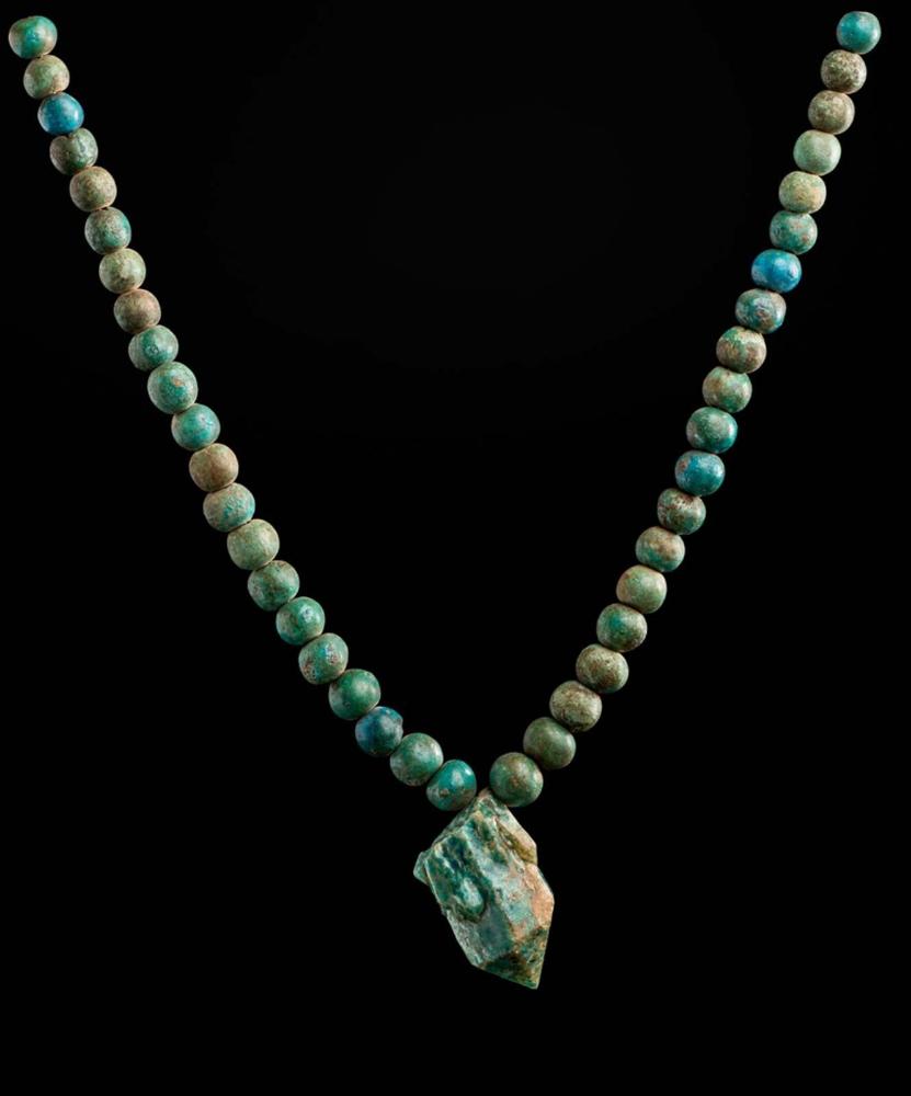 Belt with a glazed quartz pendant