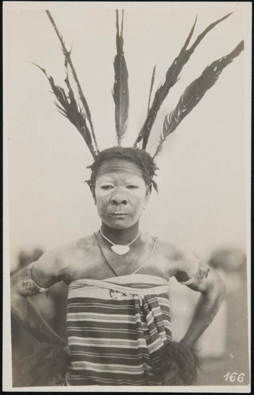 Half-length portrait of a woman with face paint and a feather headdress