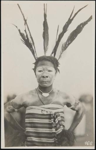 Half-length portrait of a woman with face paint and a feather headdress