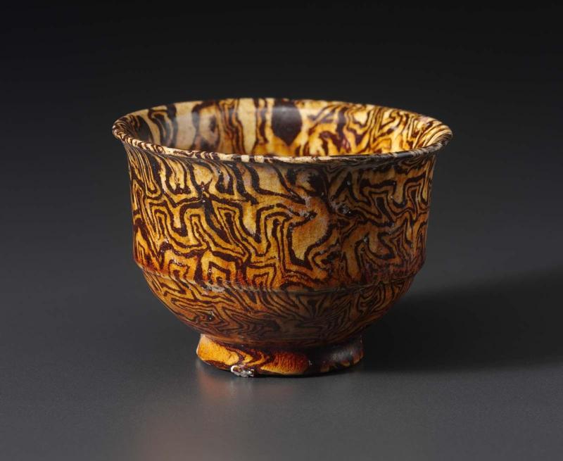 Marbelized cup decorated with amber glaze
