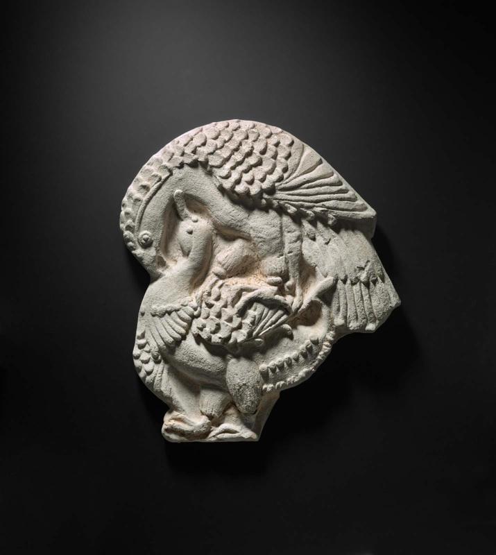 Relief of a hawk attacking a duck