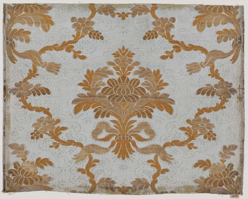 Floral design in gold on white ground patterned in weft