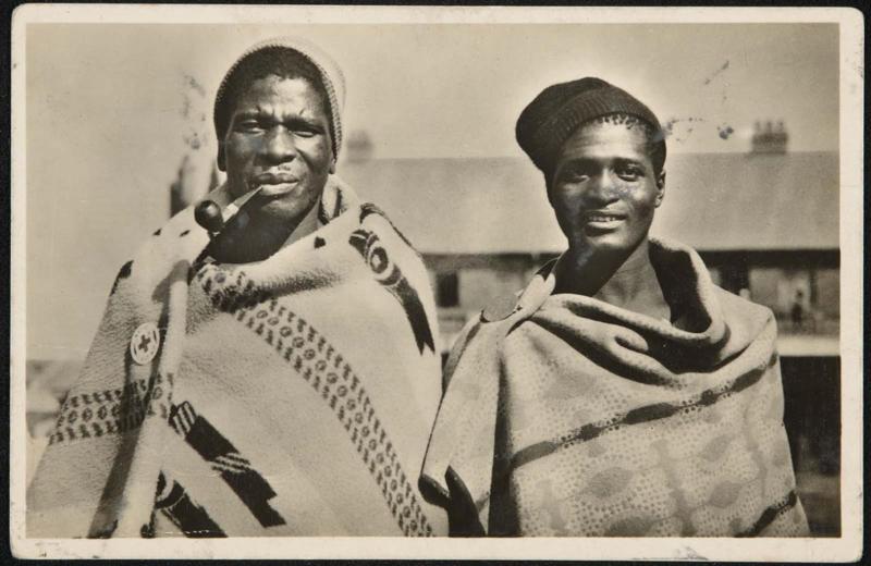 Two men, one smoking a pipe.
