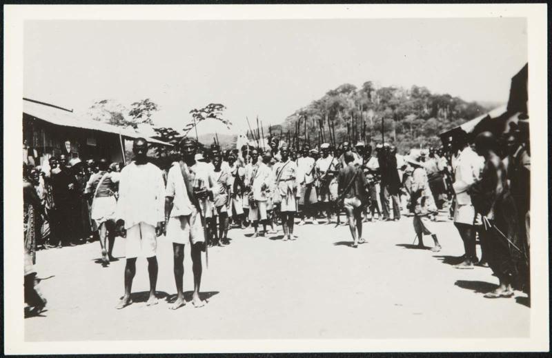 AFRICA - The guardsmen of the chief parade through the village streets.