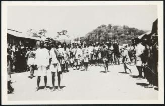 AFRICA - The guardsmen of the chief parade through the village streets.