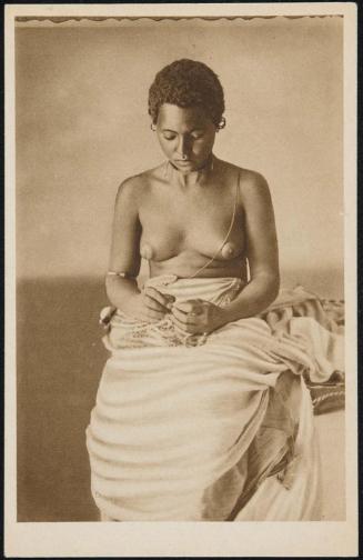 Young woman sitting down, looking down