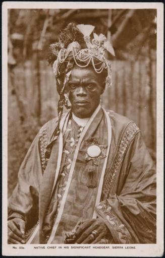 NATIVE CHIEF IN HIS SIGNIFICANT HEADGEAR, SIERRA LEONE.