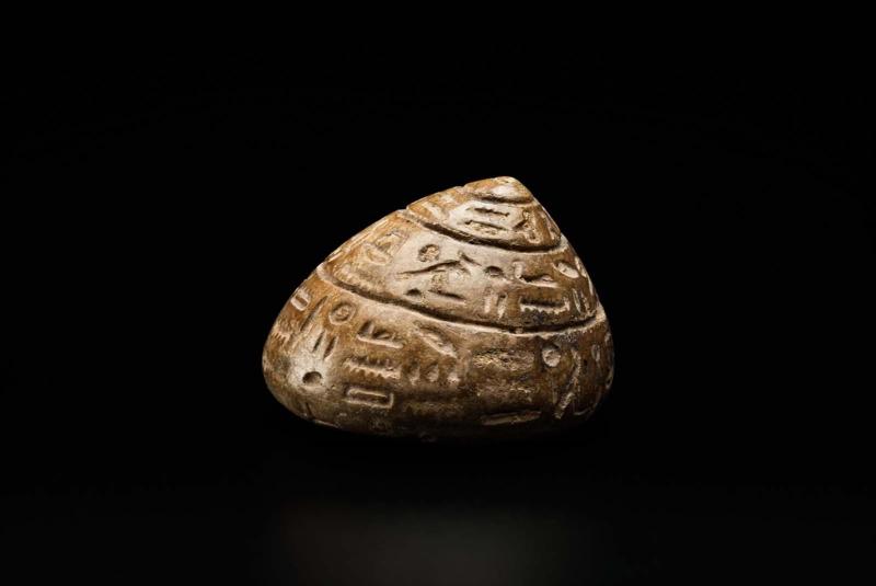 Inscribed shell-shaped stone