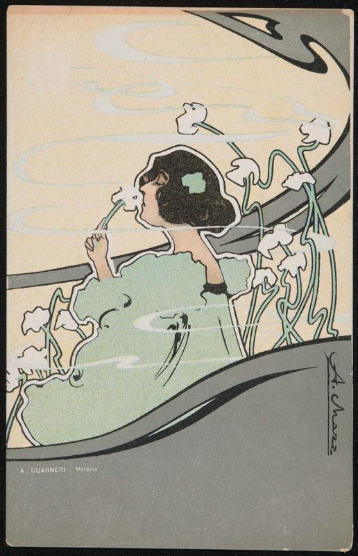 Woman in a green dress smelling flowers