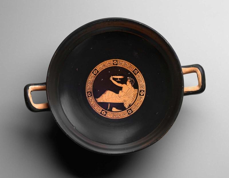 Drinking cup (kylix) with a youth playing a drinking game (kottabos)