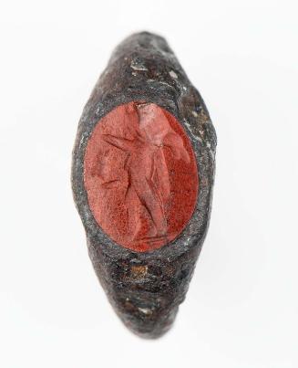 Ring with oval gem with Cupid walking left