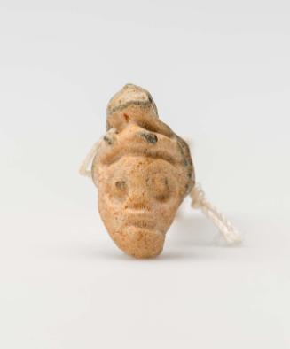 Amulet of a grotesque head