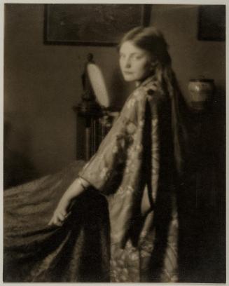 Florence Peterson in a kimono holding a mirror